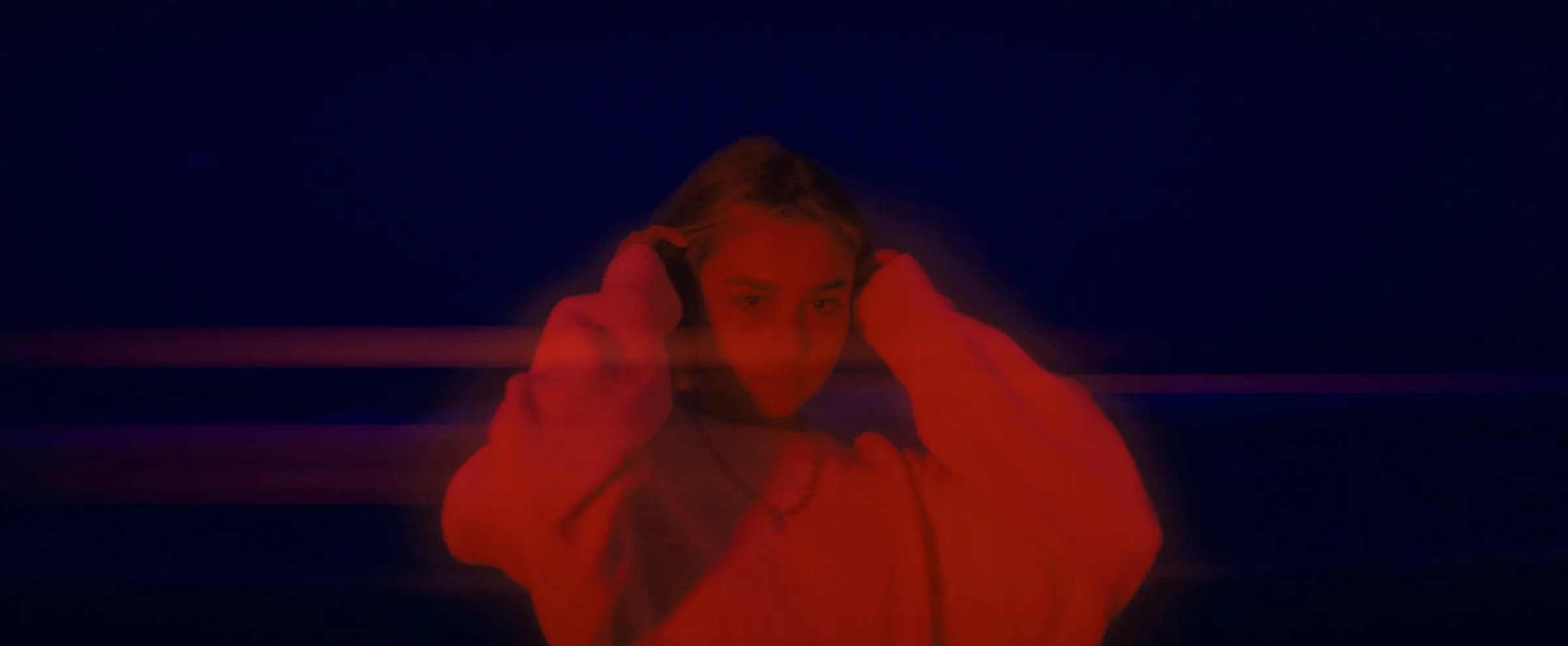 Red-lit portrait in oversized wardrobe styling