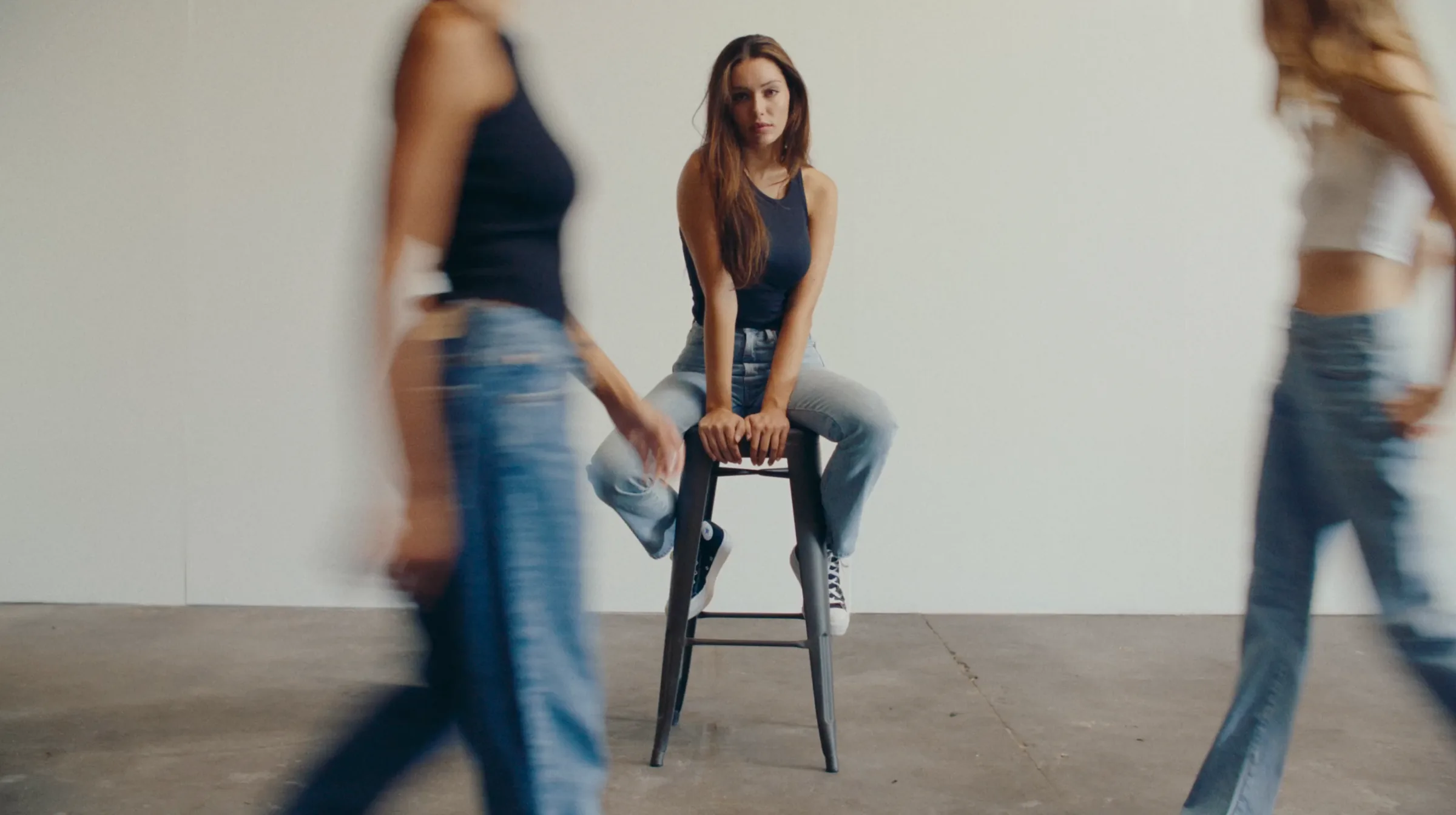 Denim campaign portrait with figures crossing the frame