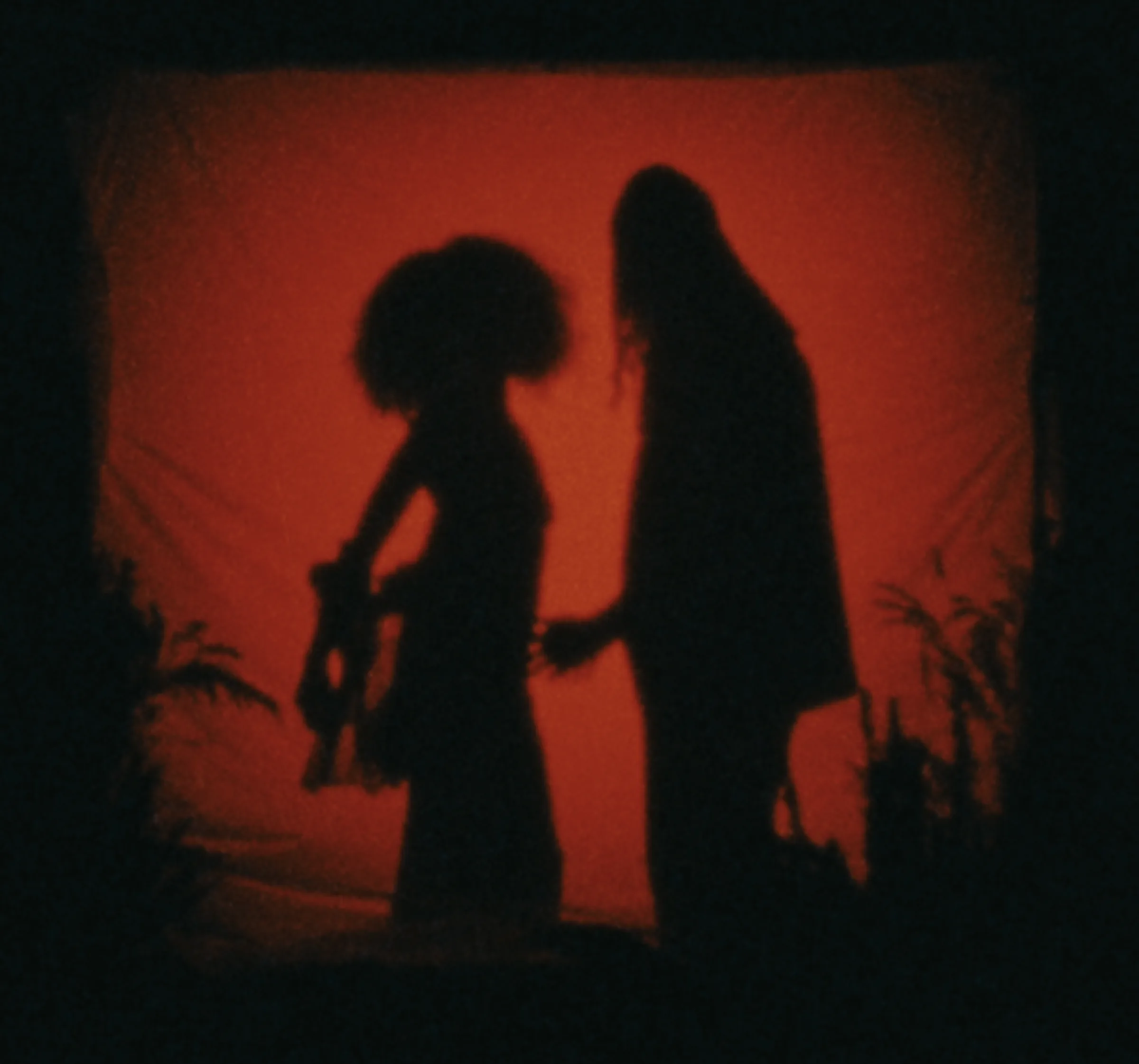 Two shadowed figures against a deep red backdrop