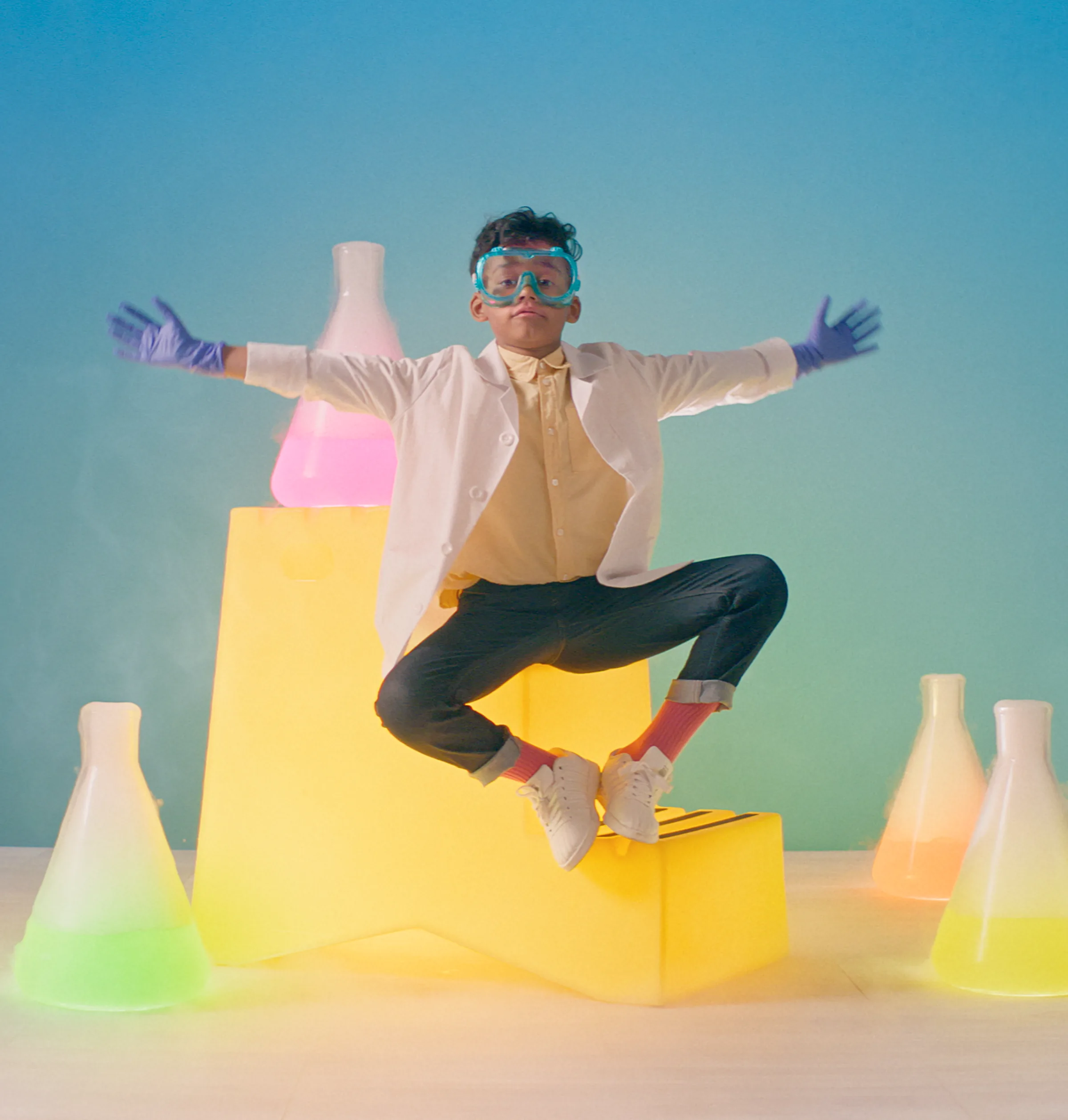 Young scientist surrounded by glowing laboratory bottles
